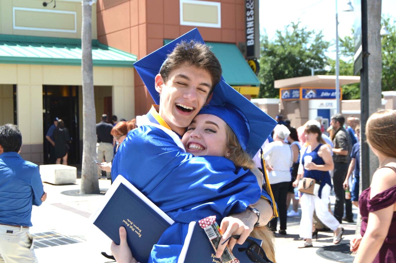 Carter at his high school graduation, hugging his friend Brittany.